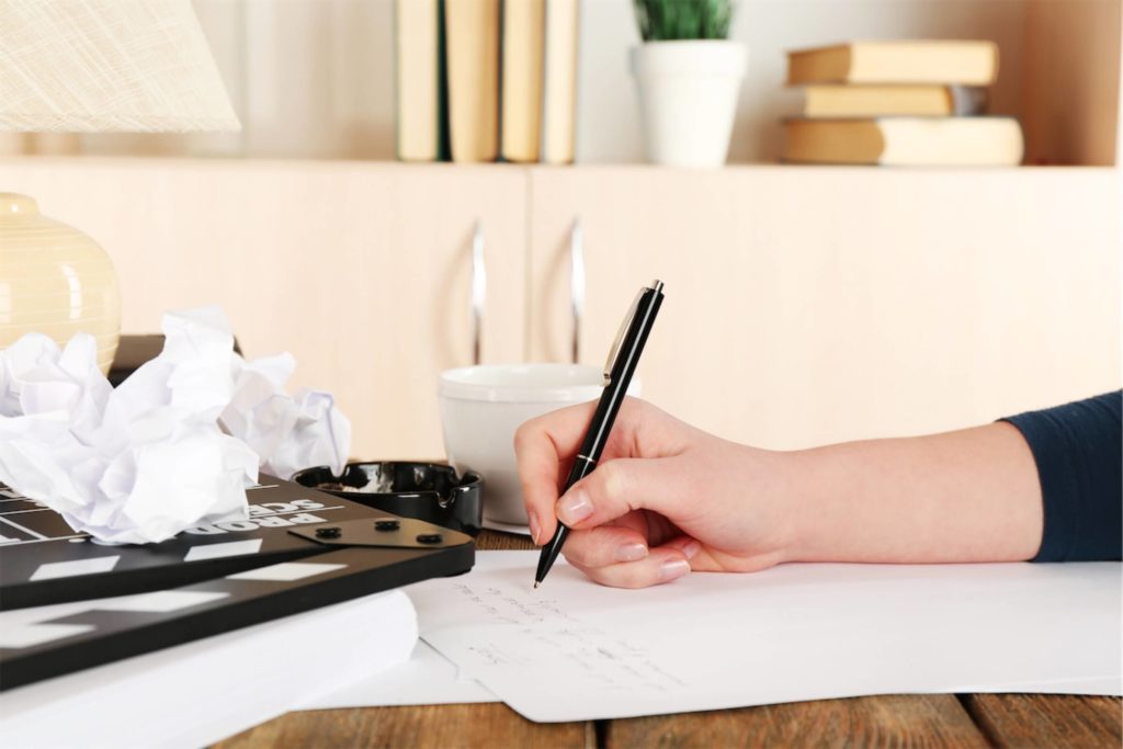 Drafting a long-form article with a pen and paper